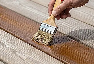 Staining a deck with a brush